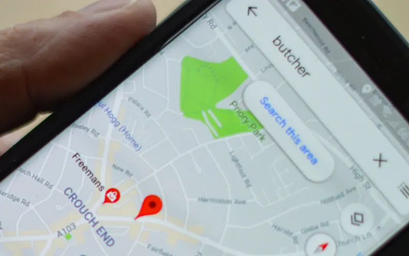A phone showing a map search with location pins