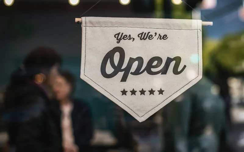 A shop sign that reads Yes, we're open